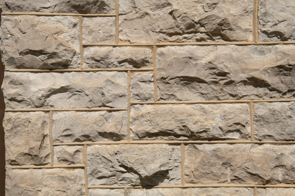 A wall constructed with rough limestone blocks.